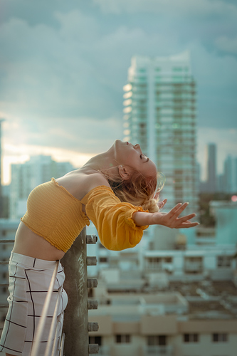 Dancer leaning back over a building.